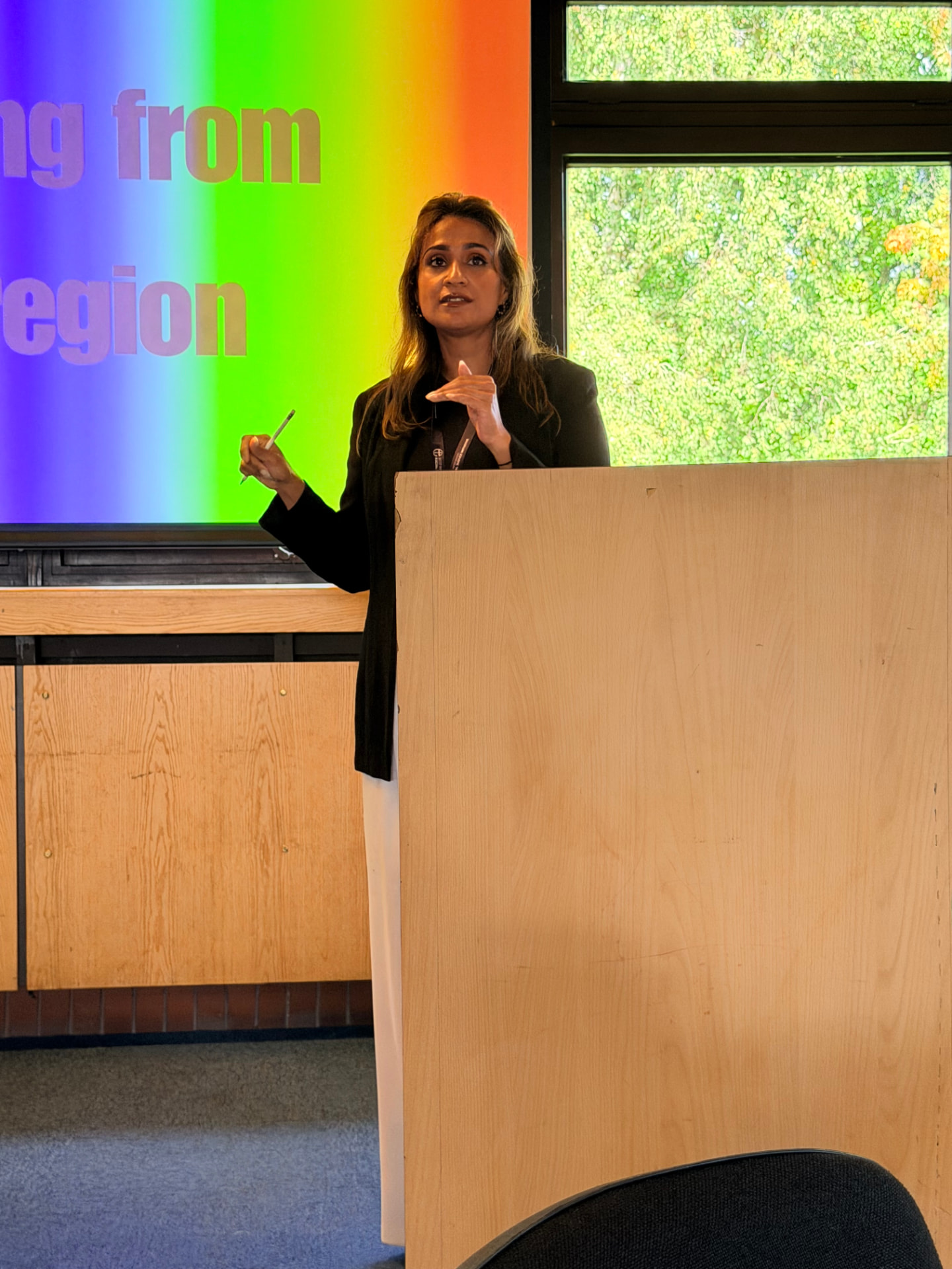 Anira Khokhar giving a keynote at a lectern